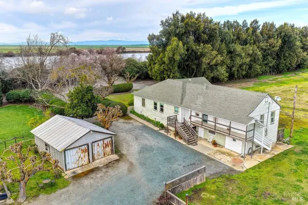 a living room with a bed and dresser next to a window
