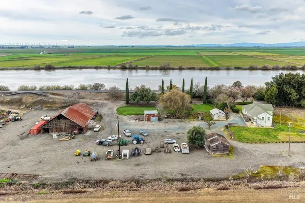 a wooden bench sitting in the middle of a field