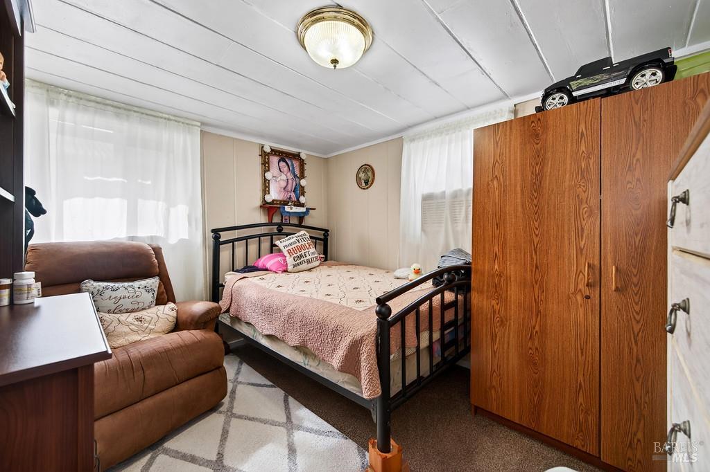3834 Highway 84 Walnut Grove, CA 95690 - Photo 83 of 84 a bedroom with a bed and a chandelier