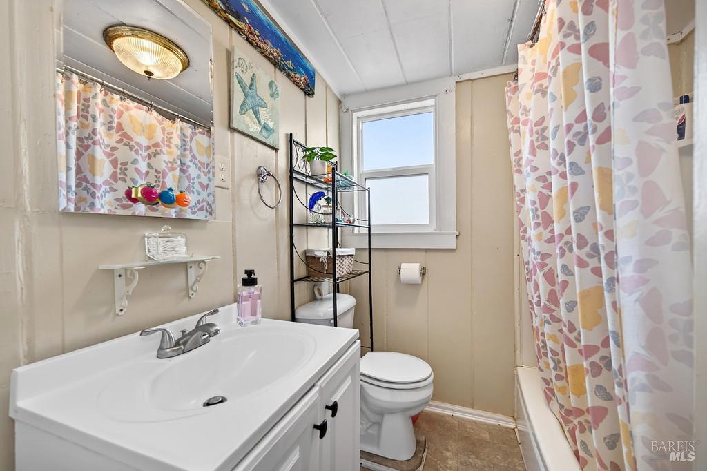 3834 Highway 84 Walnut Grove, CA 95690 - Photo 84 of 84 a bathroom with a sink a toilet and shower curtain