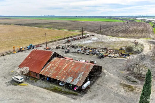 a view of a lake with a big yard and large trees