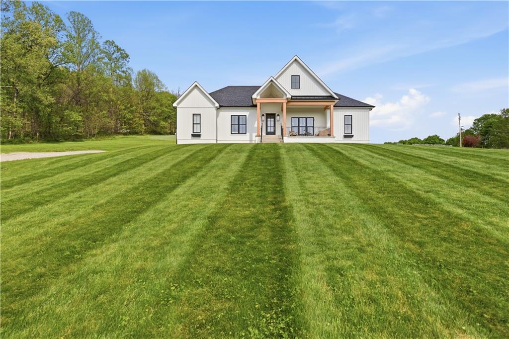 315 Stewarton Road Mill Run, PA 15464 - Photo 4 of 47 a front view of a house with a yard