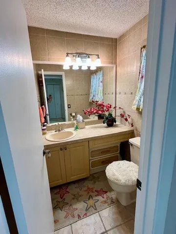 a bathroom with a sink toilet and a mirror