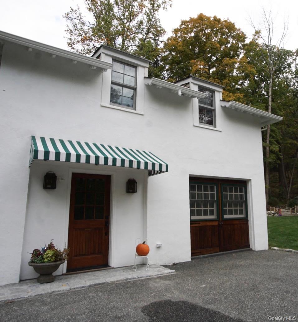 20 Ridge Road Tuxedo Park, NY 10987 - Photo 1 of 13 a front view of a house with garage