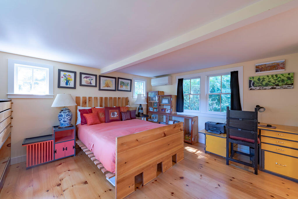 160 Paine Hollow Road Wellfleet, MA 02667 - Photo 23 of 71 a bedroom with a bed and wooden floor
