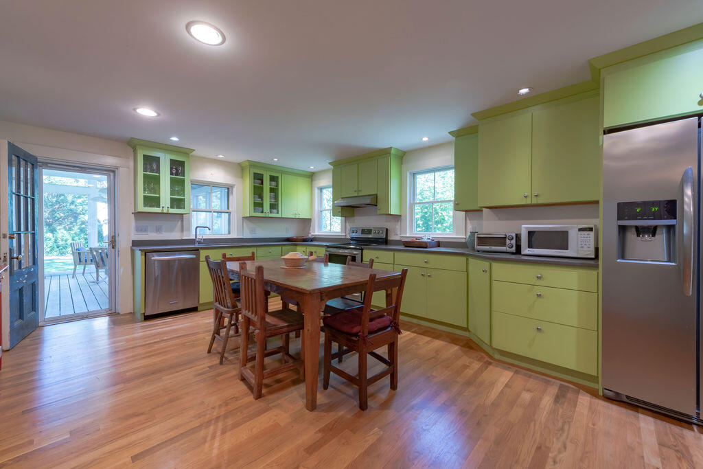 160 Paine Hollow Road Wellfleet, MA 02667 - Photo 3 of 71 a kitchen with a table chairs sink and cabinets