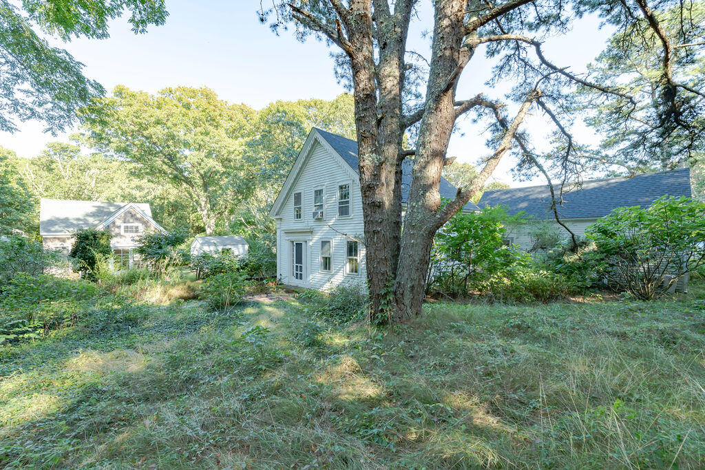 160 Paine Hollow Road Wellfleet, MA 02667 - Photo 59 of 71 a view of a house with a tree in the yard