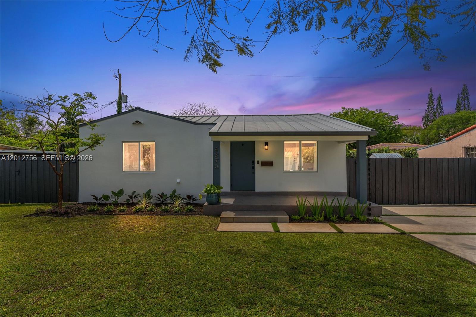 4370 Southwest 11th Street Miami, FL 33134 - Photo 1 of 21 a front view of a house with a yard