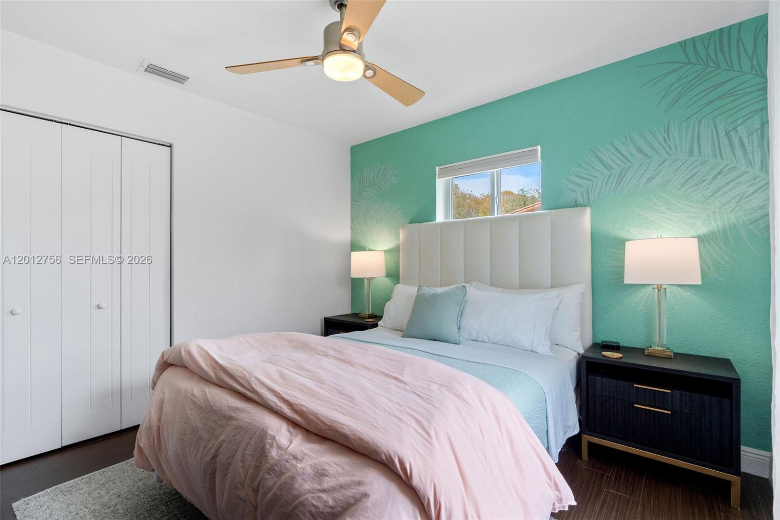 4370 Southwest 11th Street Miami, FL 33134 - Photo 18 of 21 a bedroom with a bed and a lamp