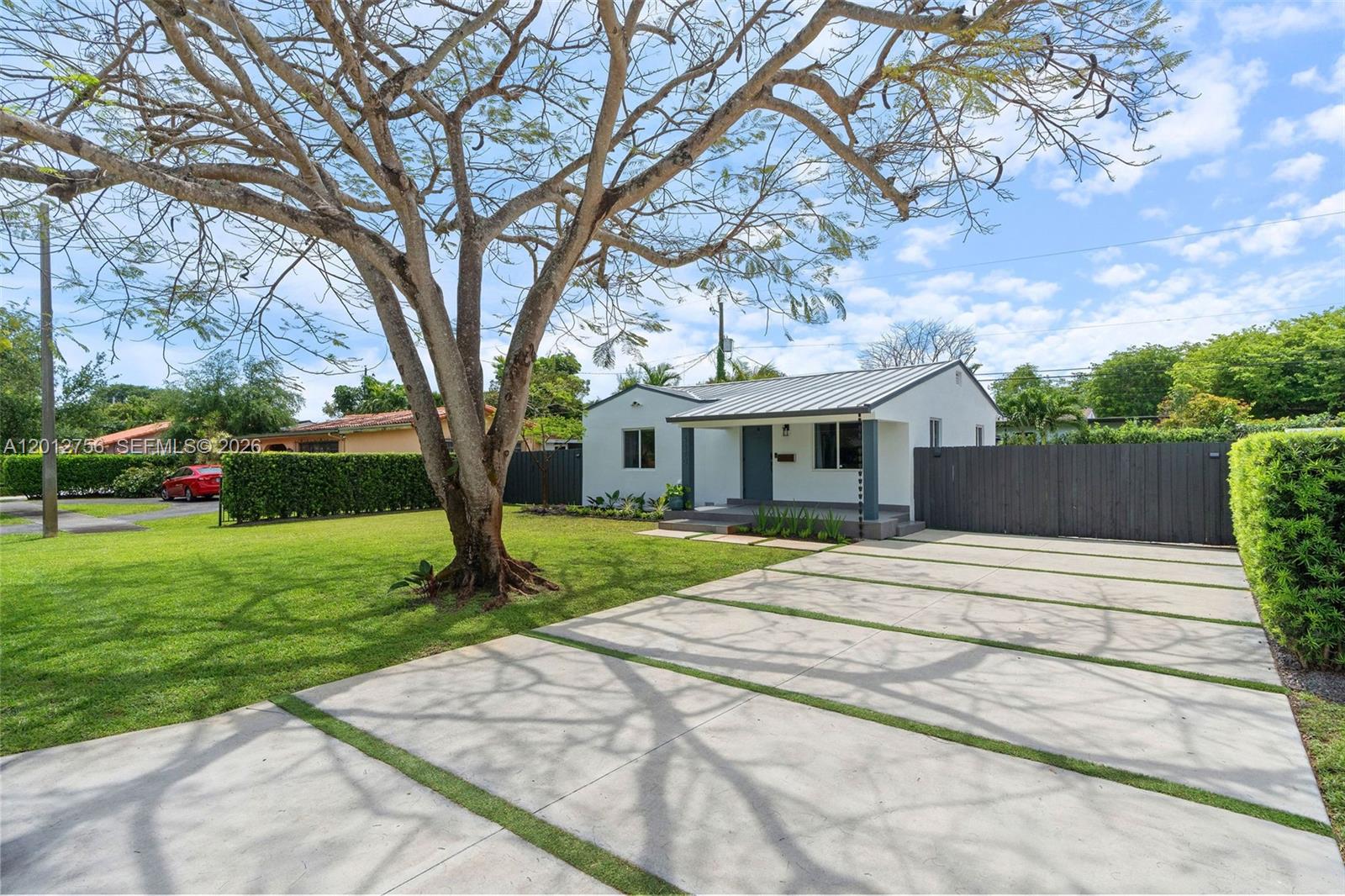 4370 Southwest 11th Street Miami, FL 33134 - Photo 2 of 21 a front view of house with yard and green space