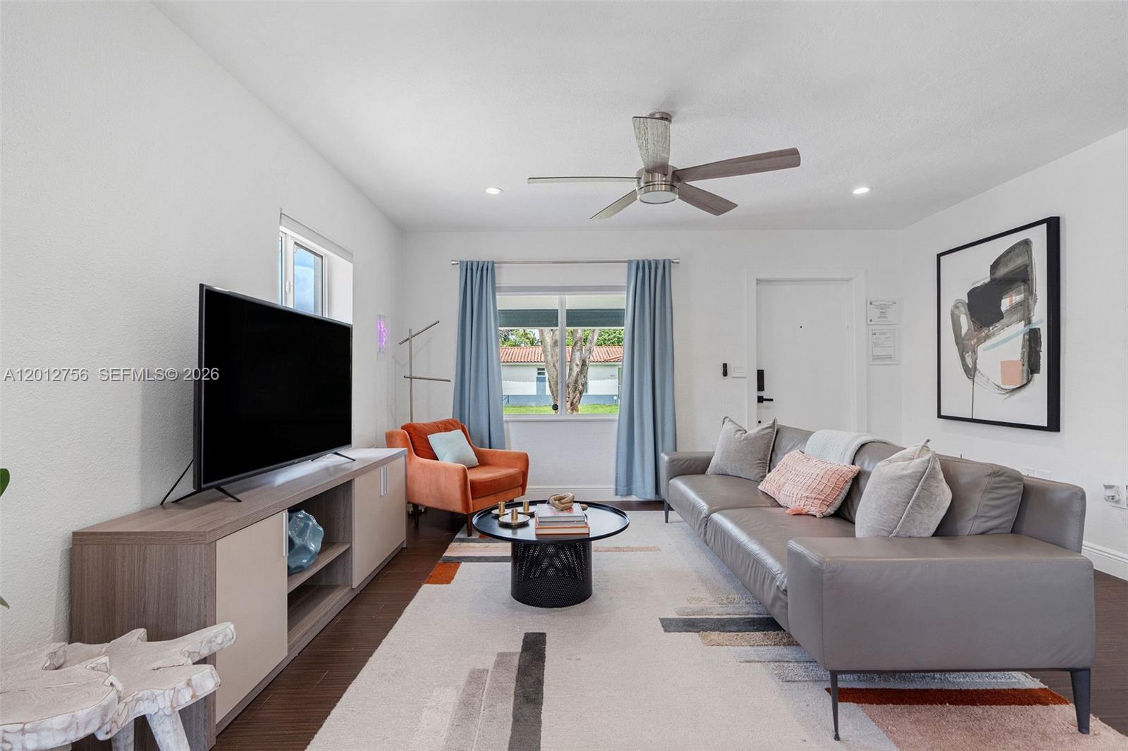 4370 Southwest 11th Street Miami, FL 33134 - Photo 9 of 21 a living room with furniture and a flat screen tv