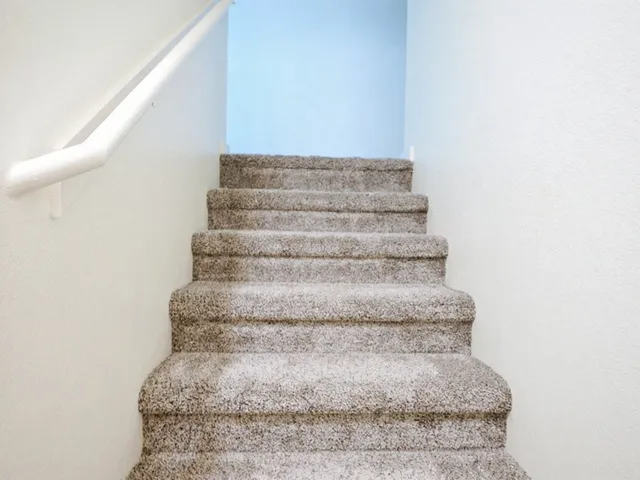 a view of staircase with white walls