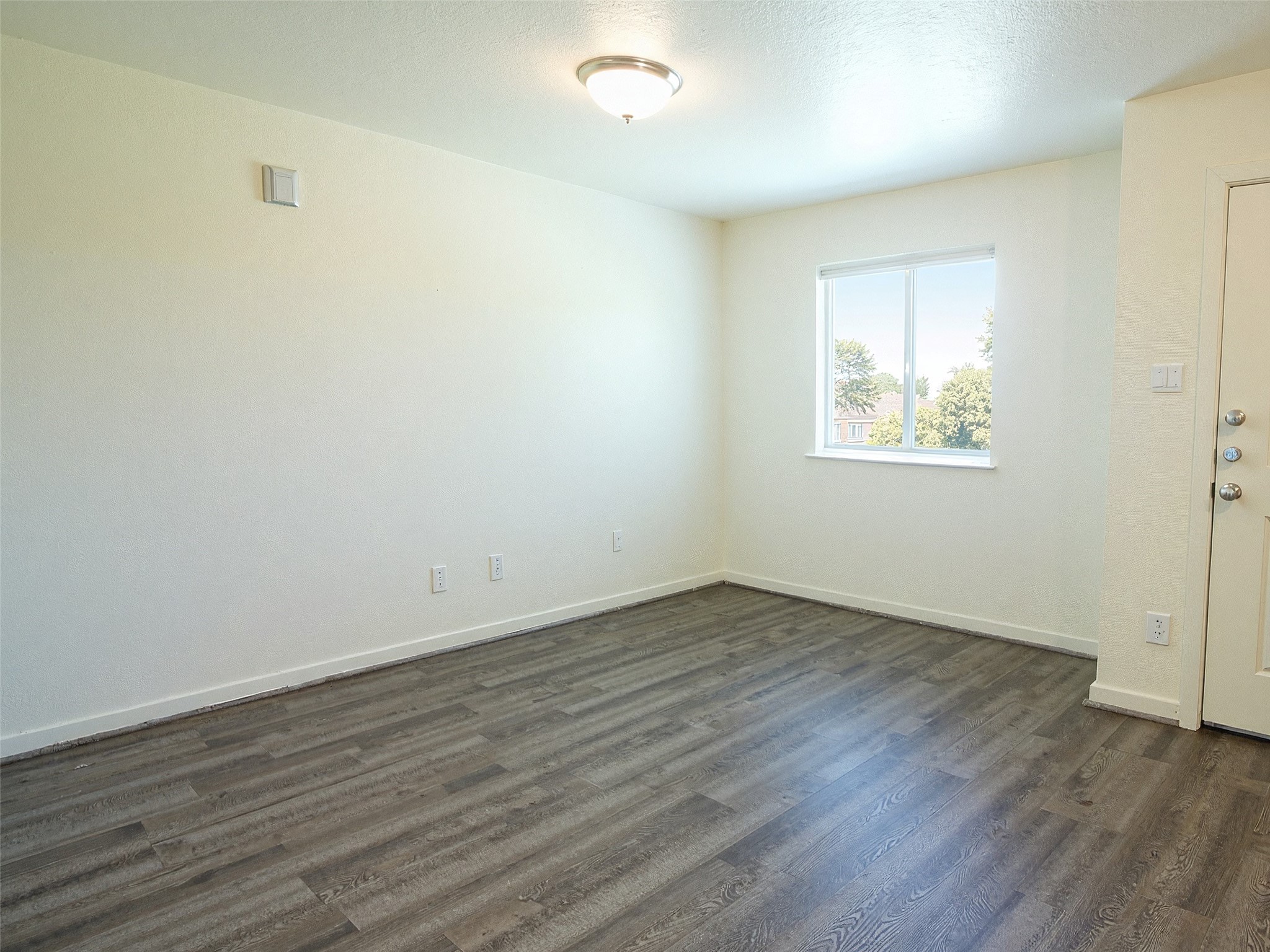 21155 Gosling Road, Unit 7C Spring, TX 77388 - Photo 4 of 24 an empty room with wooden floor and windows