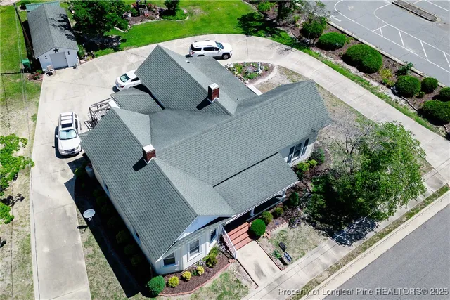 an aerial view of a house with a yard
