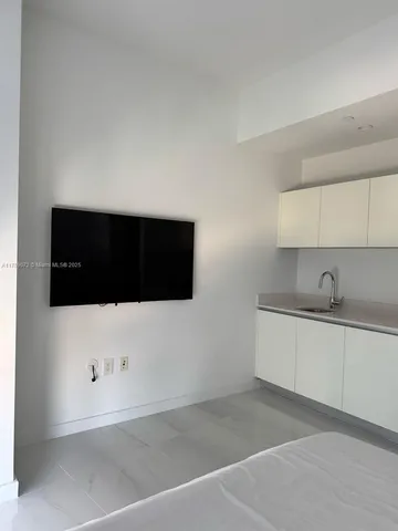 a room with pool table and windows