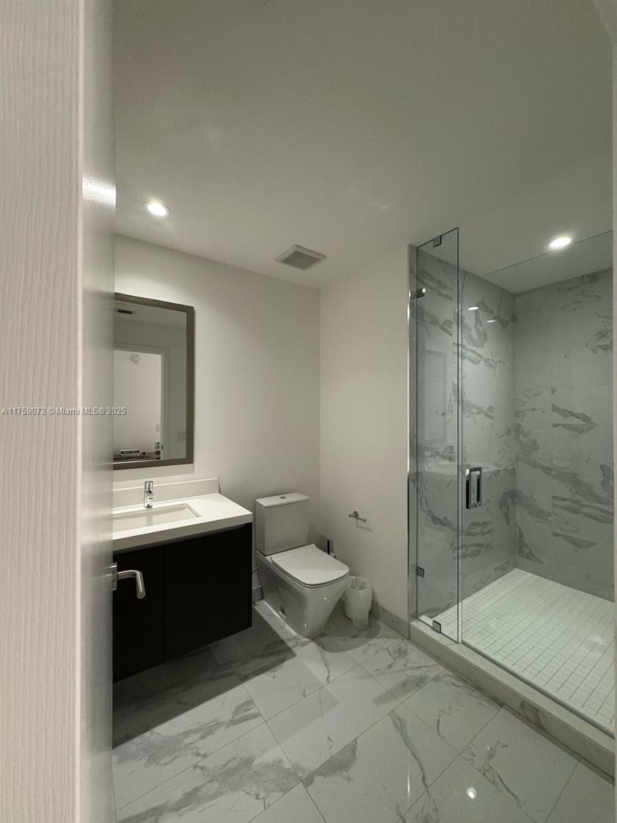 851 Northeast 1st Avenue, Unit 1401 Miami, FL 33132 - Photo 28 of 38 a bathroom with a sink toilet and shower