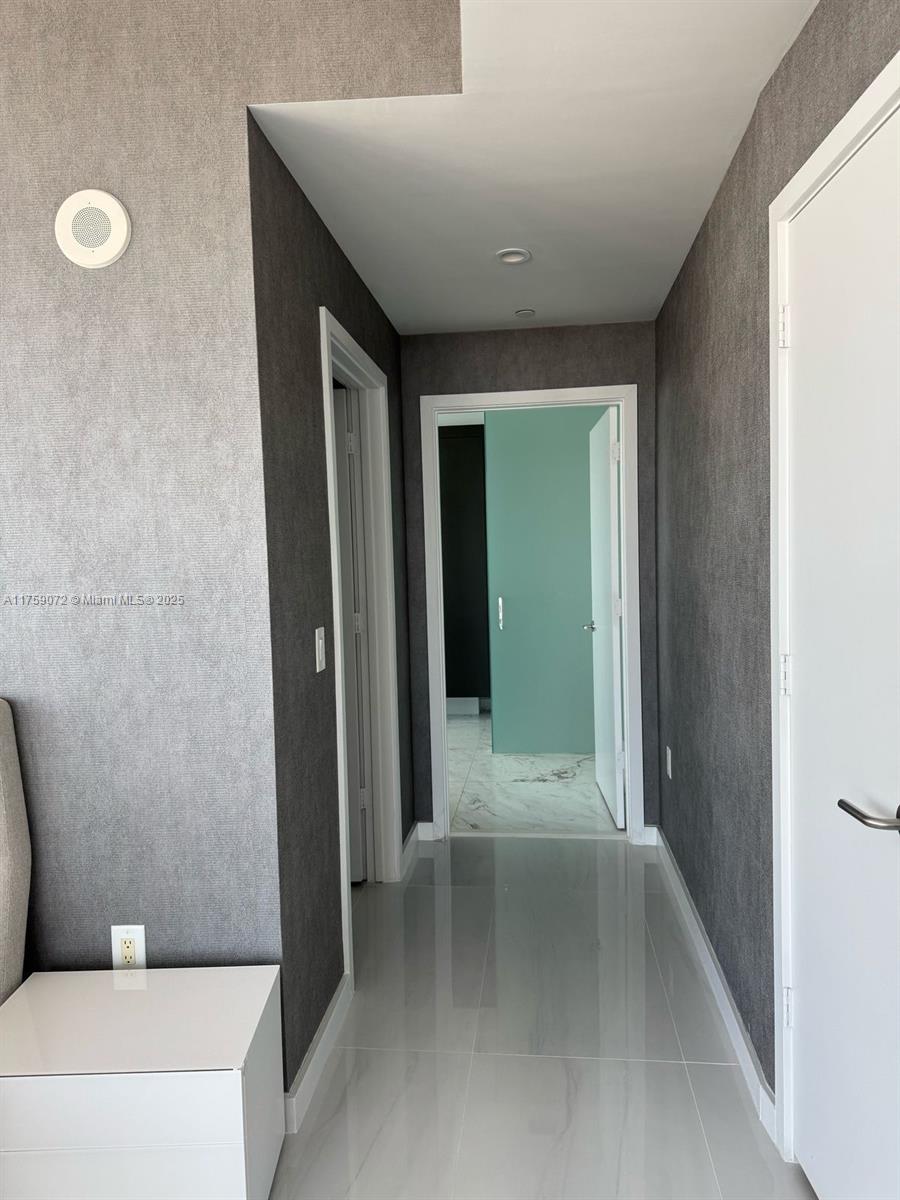 851 Northeast 1st Avenue, Unit 1401 Miami, FL 33132 - Photo 31 of 38 a view of a hallway with toilet and a tub