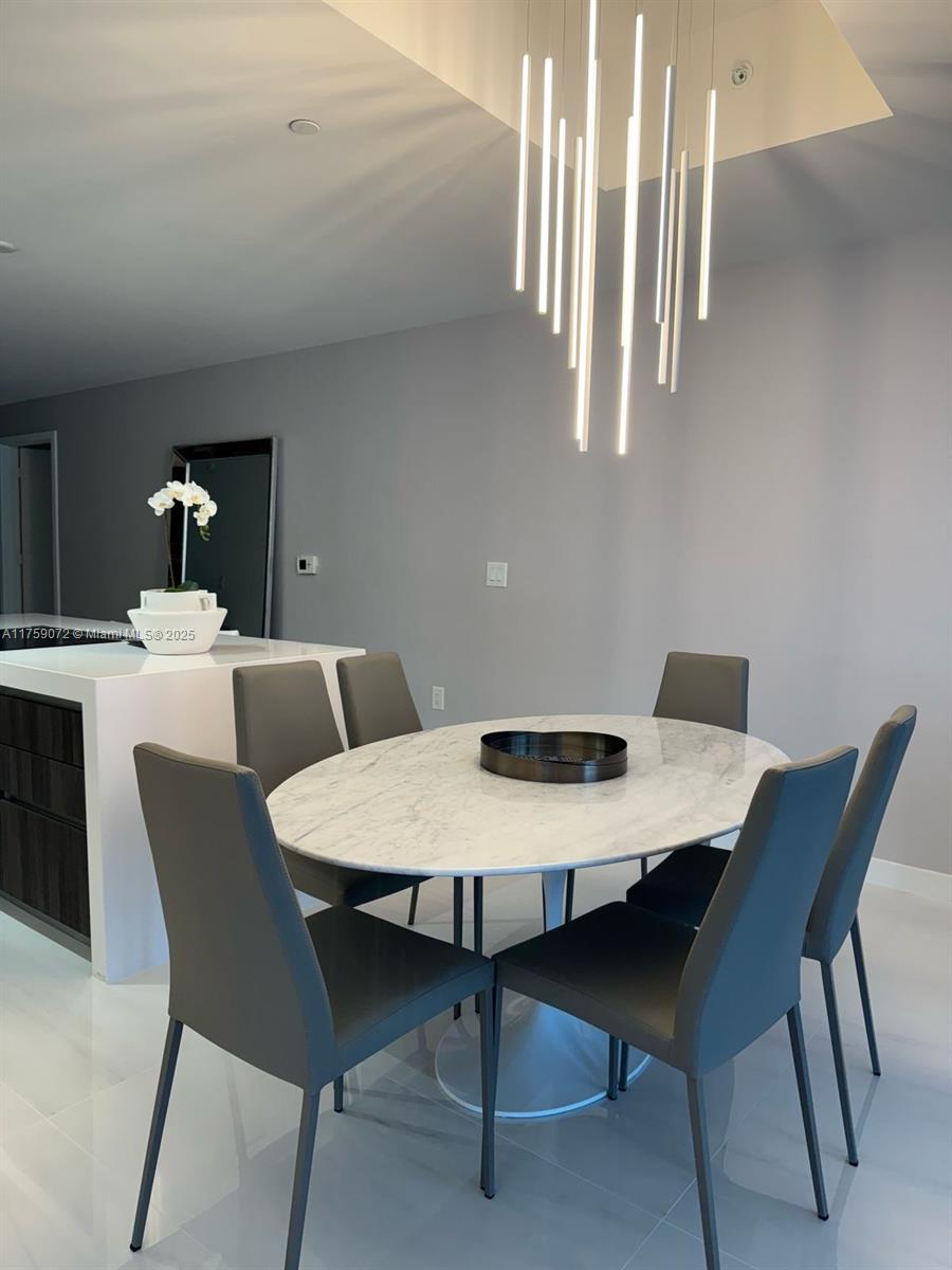 851 Northeast 1st Avenue, Unit 1401 Miami, FL 33132 - Photo 7 of 38 a view of a dining room with furniture