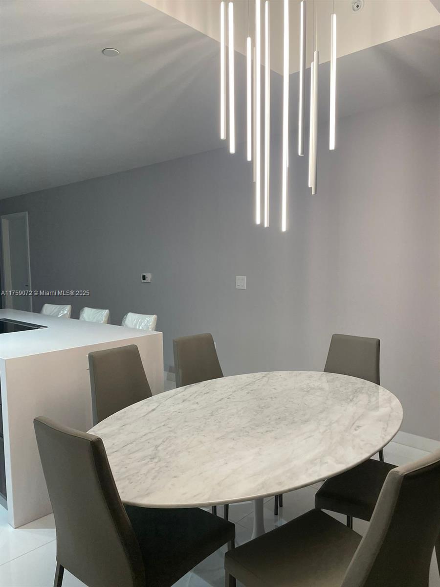 851 Northeast 1st Avenue, Unit 1401 Miami, FL 33132 - Photo 9 of 38 a view of a dining room with furniture
