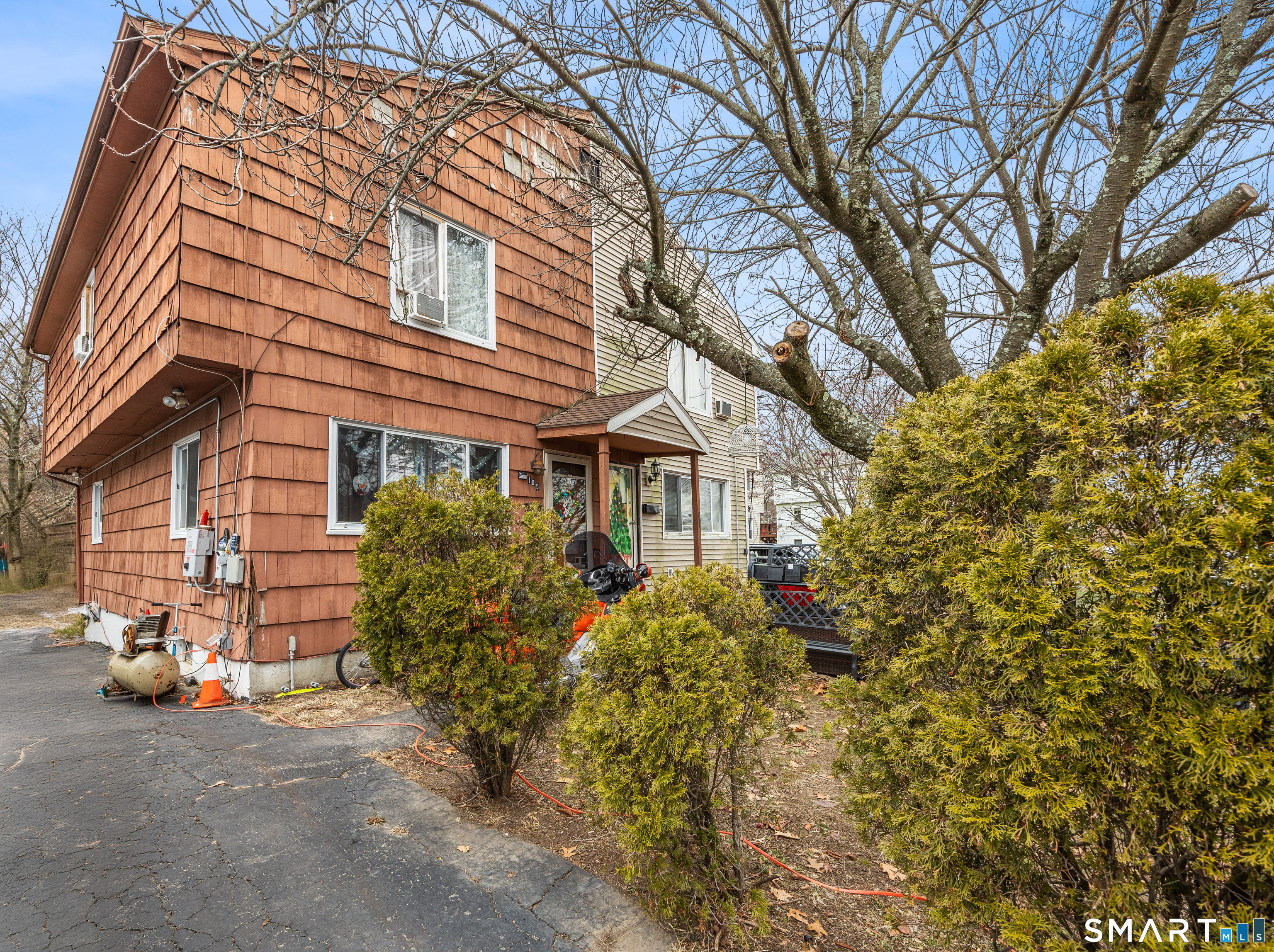 105 Pond Street Bridgeport, CT 06606 - Photo 1 of 26 front view of a house with a tree