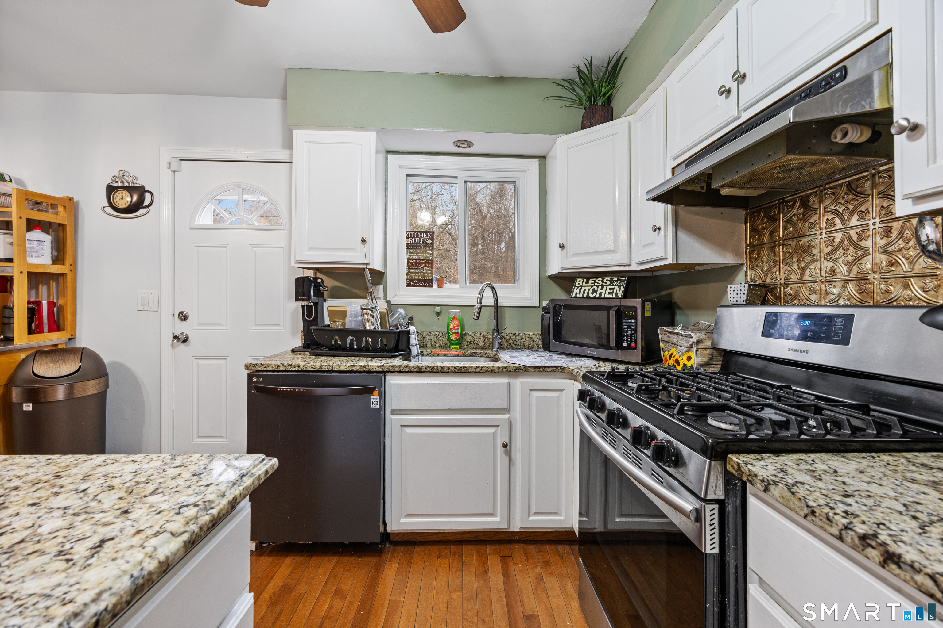 105 Pond Street Bridgeport, CT 06606 - Photo 12 of 26 a kitchen with a stove and a microwave