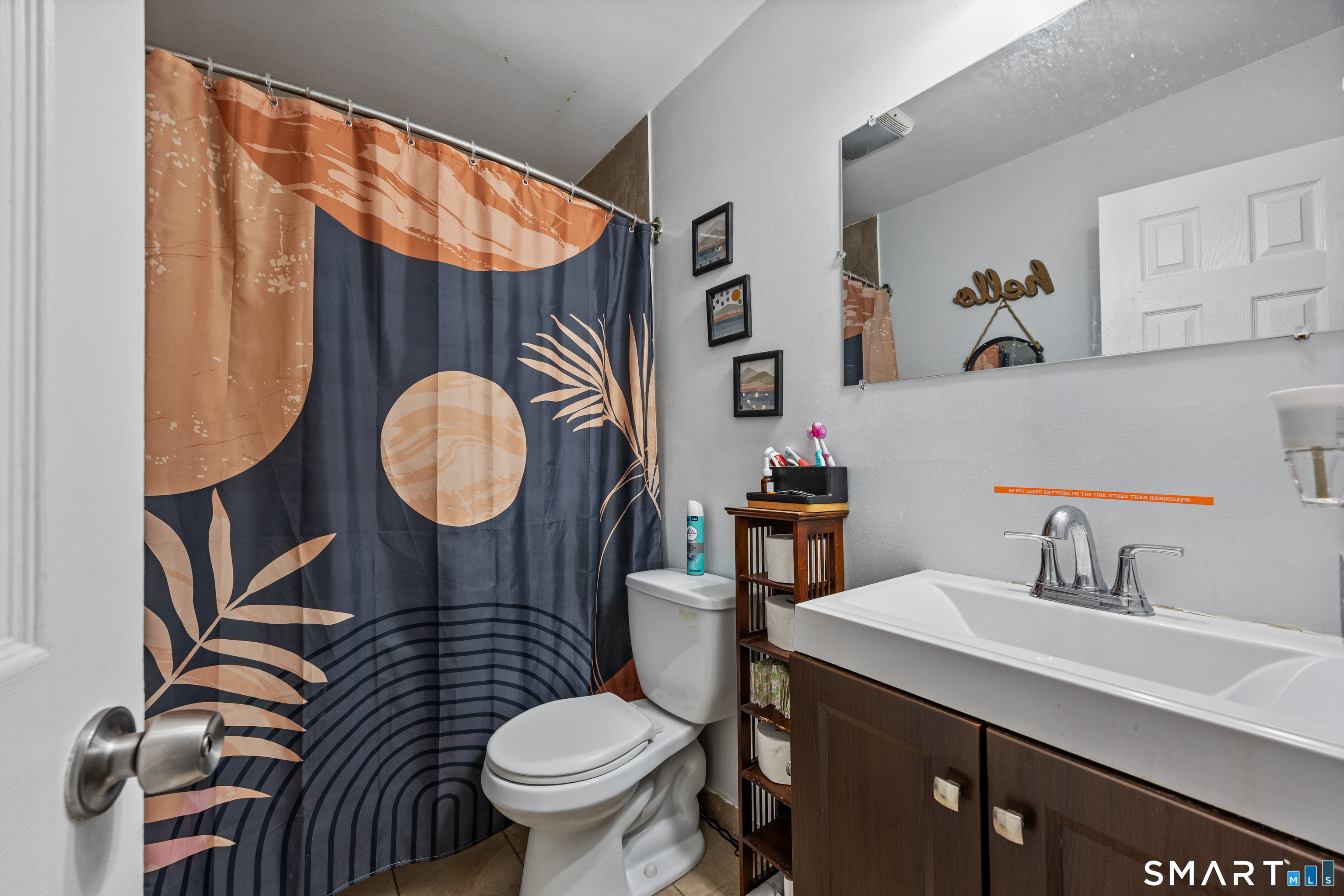 105 Pond Street Bridgeport, CT 06606 - Photo 15 of 26 a bathroom with a sink a toilet and a mirror