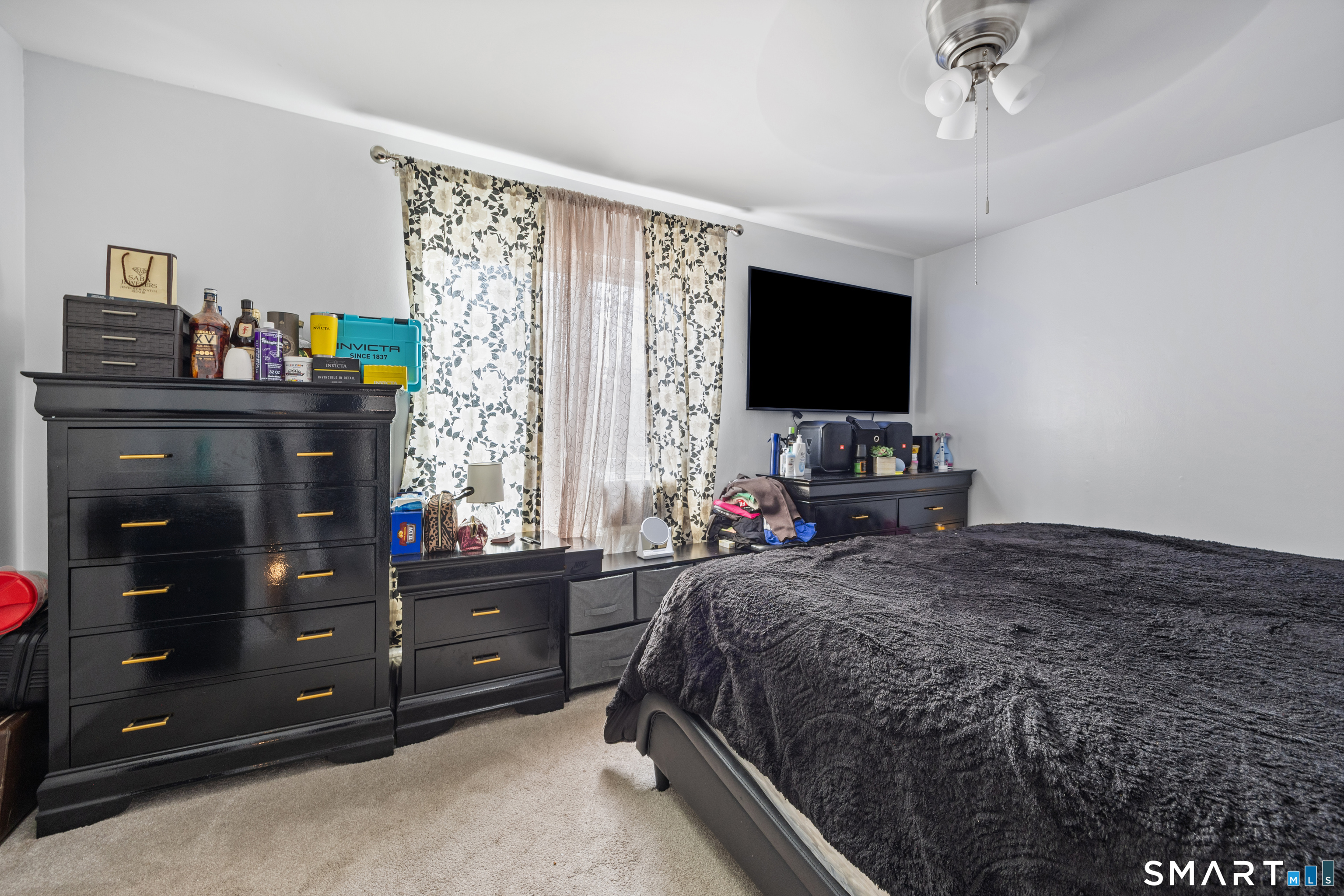 105 Pond Street Bridgeport, CT 06606 - Photo 21 of 26 a bedroom with a bed and a flat tv screen on dresser