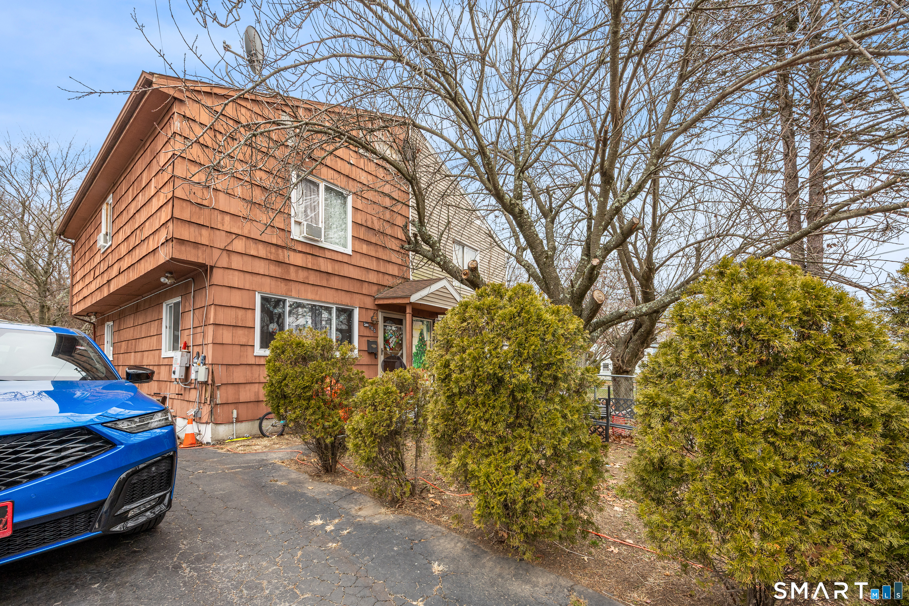 105 Pond Street Bridgeport, CT 06606 - Photo 24 of 26 a yellow house with trees in front of it