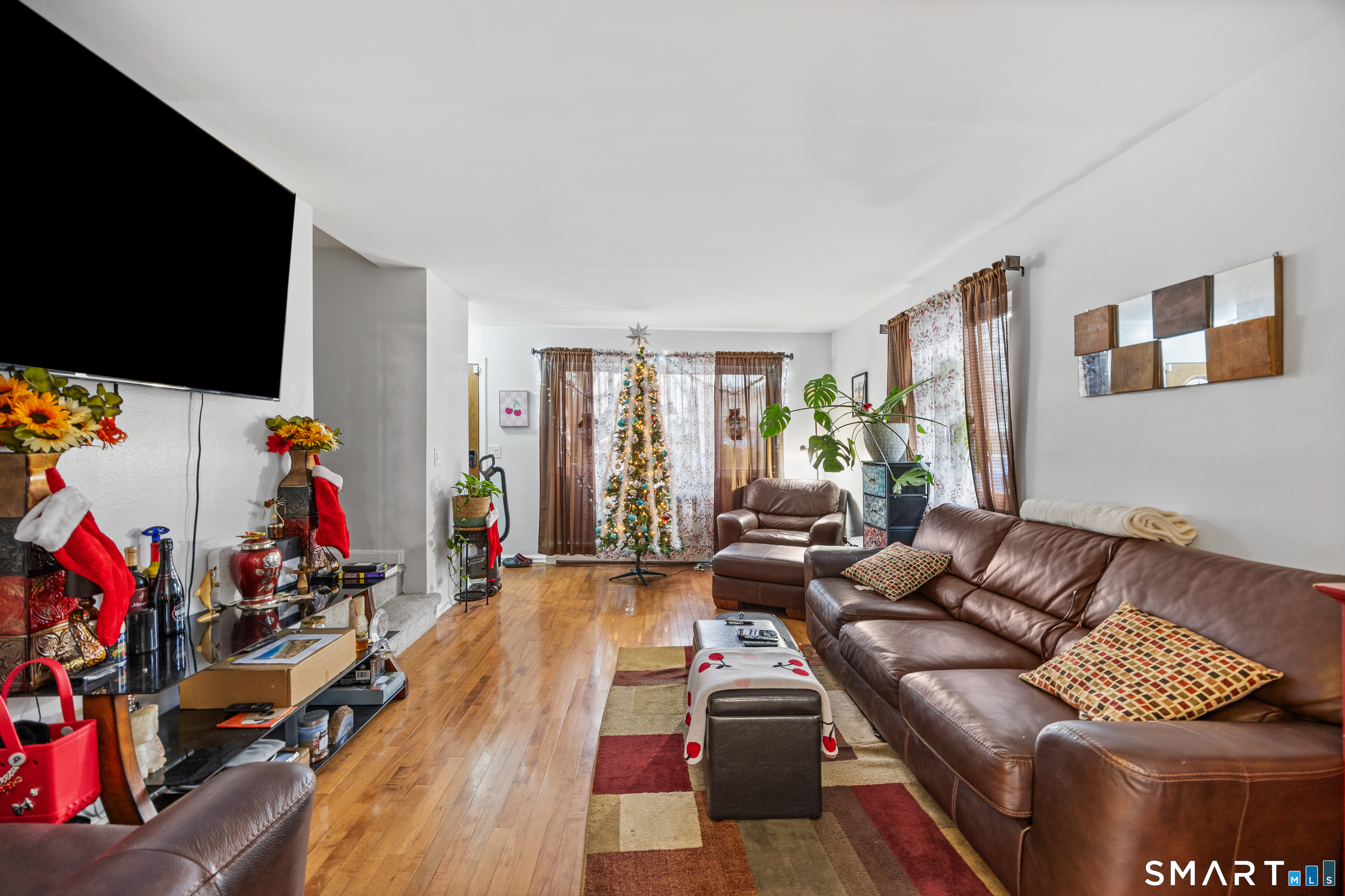 105 Pond Street Bridgeport, CT 06606 - Photo 5 of 26 a living room with furniture and a flat screen tv