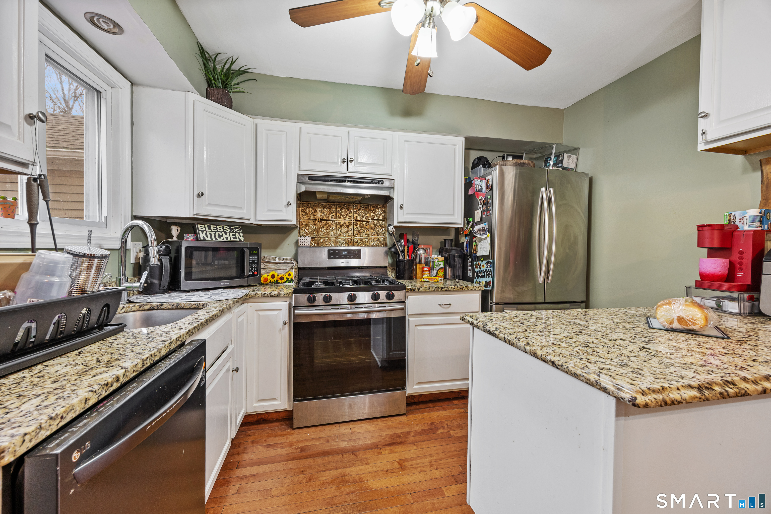 105 Pond Street Bridgeport, CT 06606 - Photo 10 of 26 a kitchen with stainless steel appliances granite countertop a sink stove and refrigerator