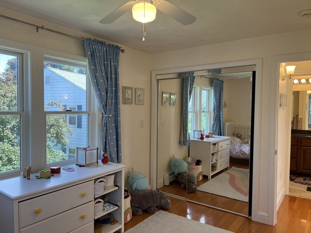 11 Garrison Road, Unit 1 Arlington, MA 02474 - Photo 33 of 42 a room with two chandeliers and furniture