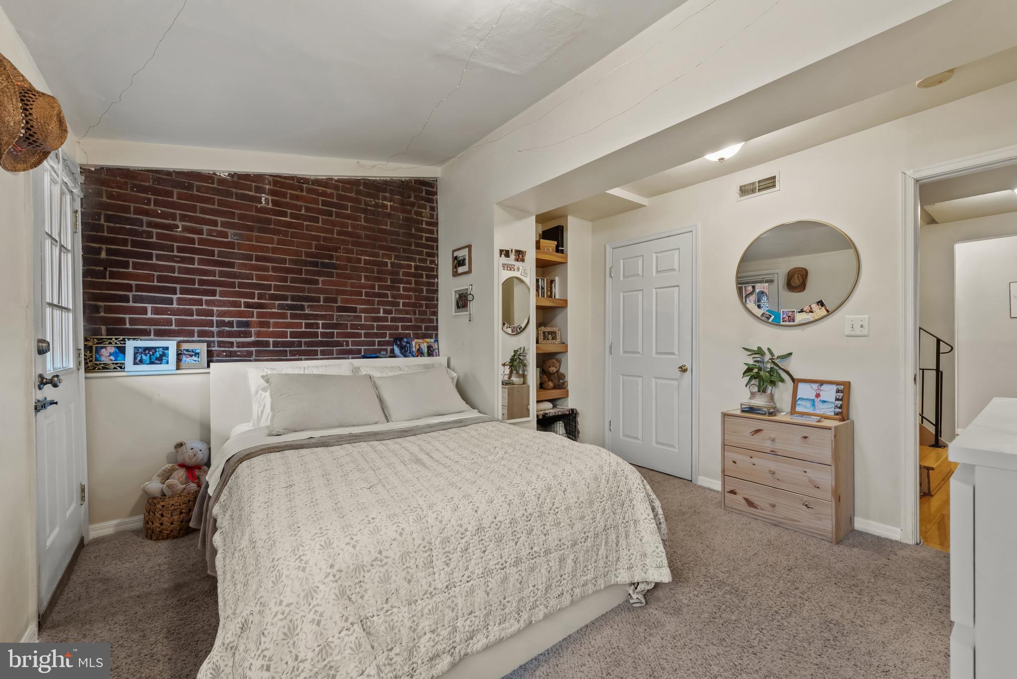 1807 East Lombard Street Baltimore, MD 21231 - Photo 11 of 30 a bedroom with a bed and a cabinets
