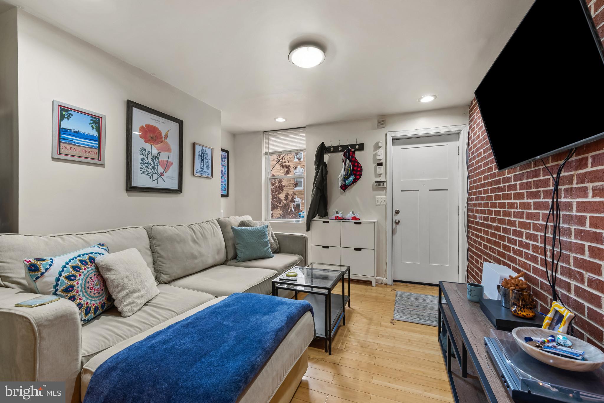 1807 East Lombard Street Baltimore, MD 21231 - Photo 2 of 30 a living room with furniture and a flat screen tv