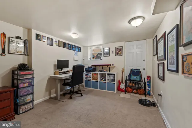 a view of a livingroom with workspace and a window