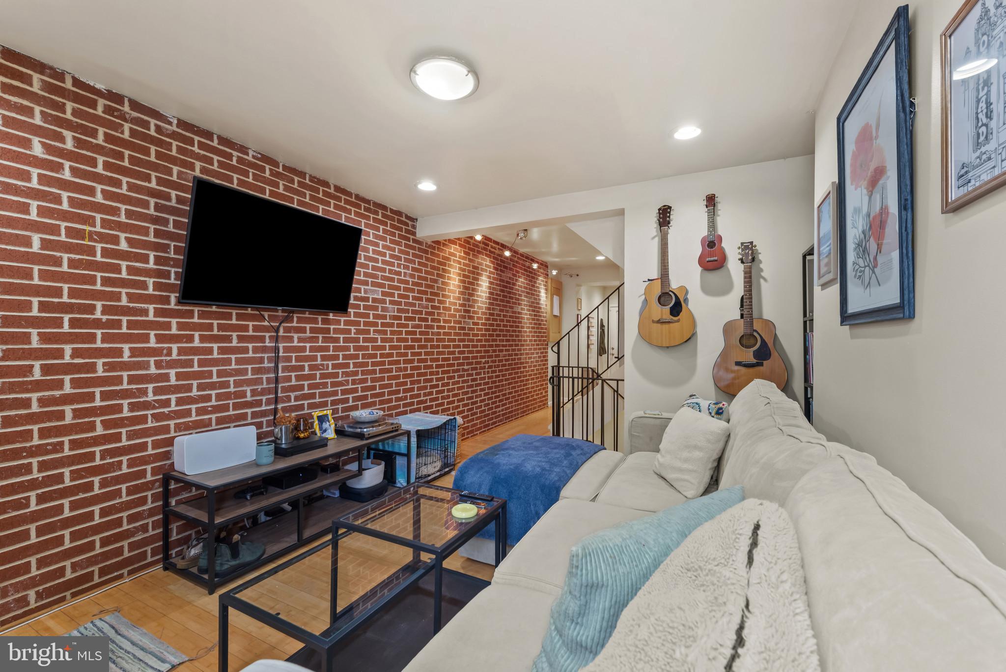 1807 East Lombard Street Baltimore, MD 21231 - Photo 4 of 30 a living room with furniture and a flat screen tv