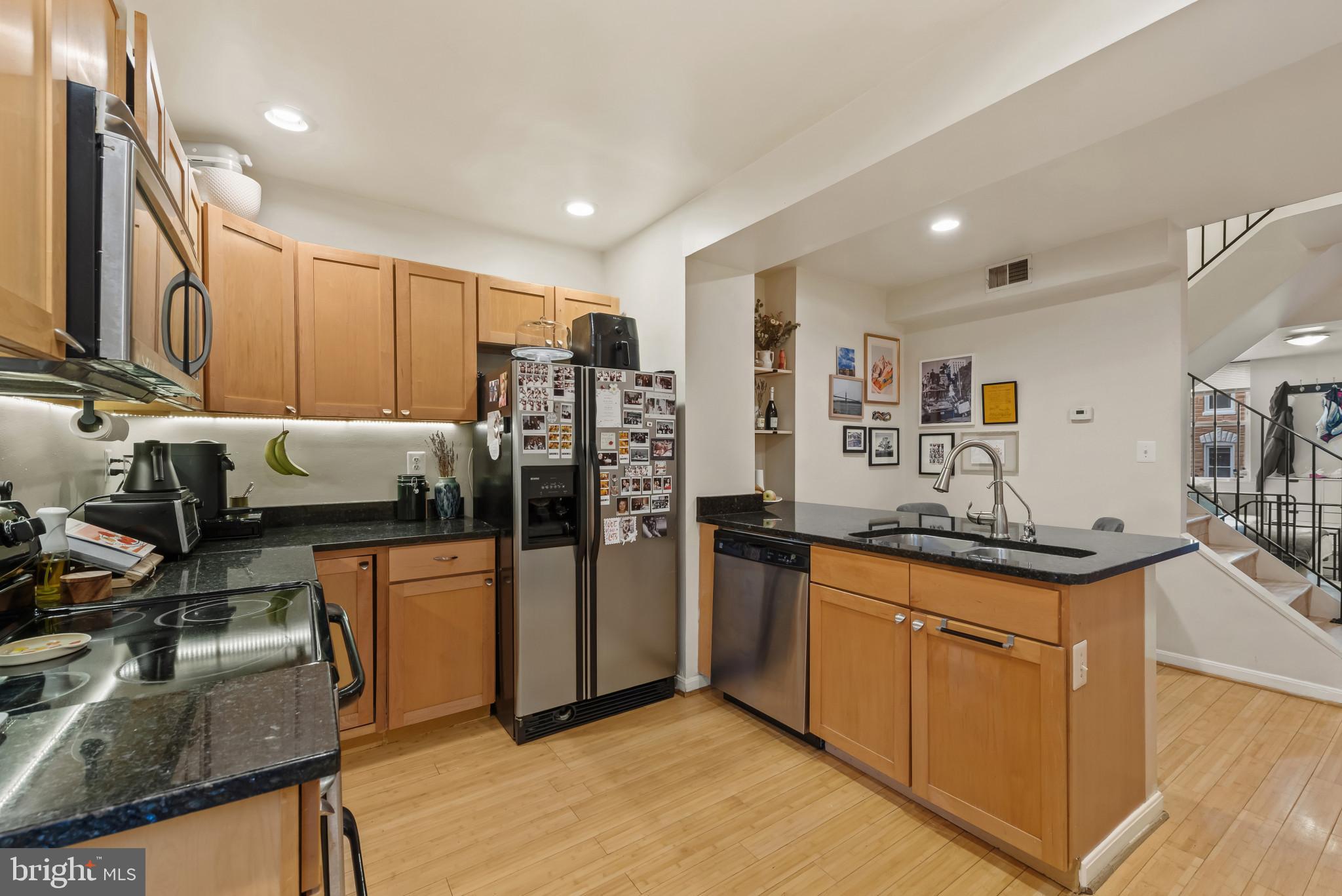 1807 East Lombard Street Baltimore, MD 21231 - Photo 6 of 30 a kitchen with stainless steel appliances granite countertop a refrigerator a sink a stove and island