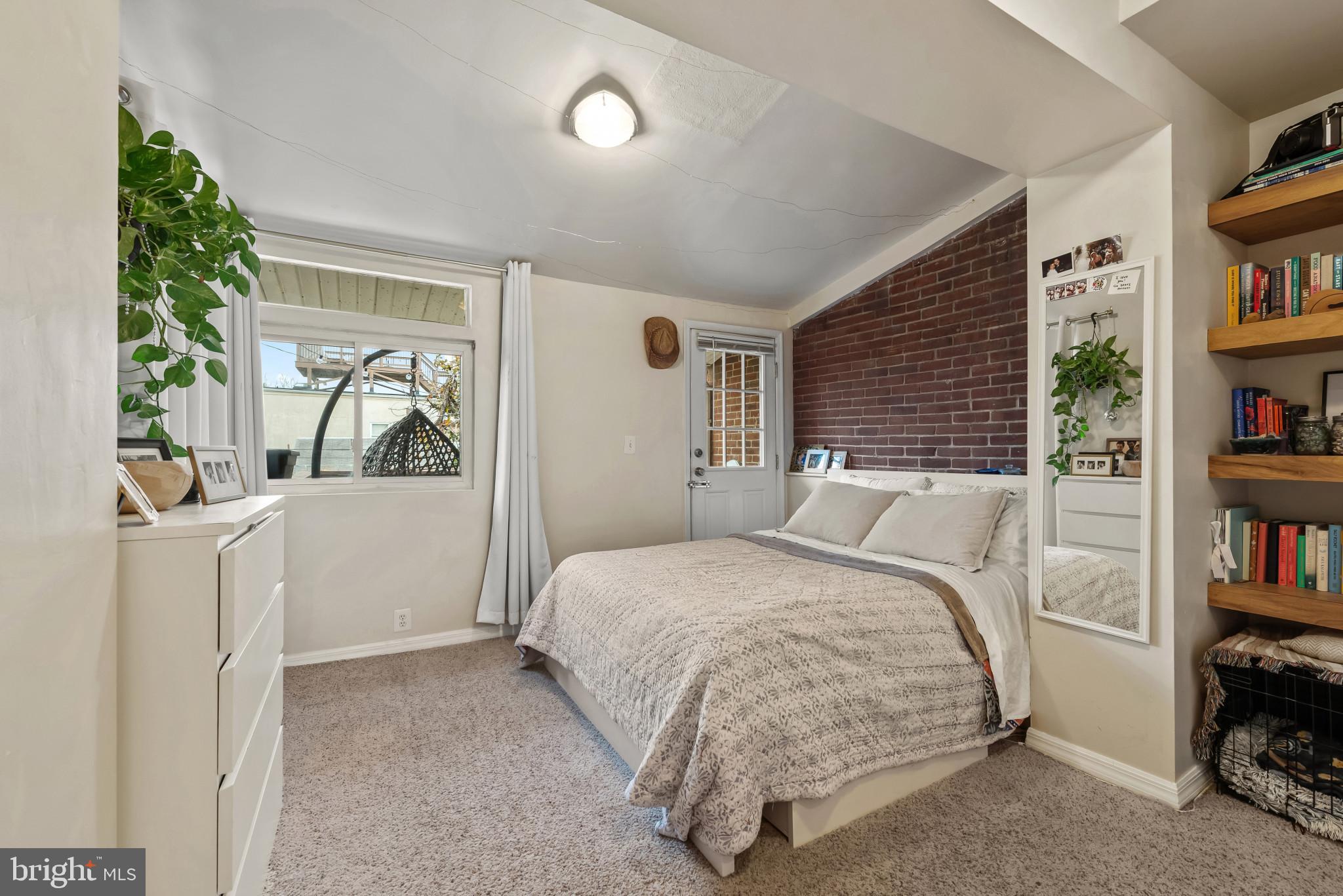 1807 East Lombard Street Baltimore, MD 21231 - Photo 10 of 30 a bedroom with a bed and a book shelf