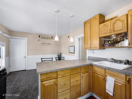 a bathroom with a granite countertop sink a mirror and a shower