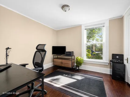a view of a workspace with furniture and a window