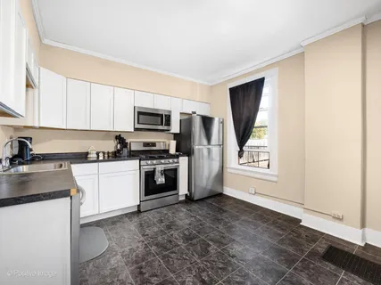 a kitchen with a refrigerator stove and microwave