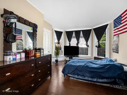 a bedroom with a bed and flat screen tv