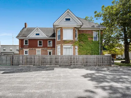 a front view of a house with a fence