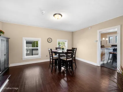 a view of a dining room with furniture and wooden floor