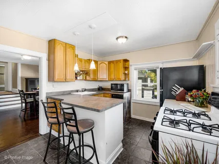 a kitchen that has a stove and a table in it