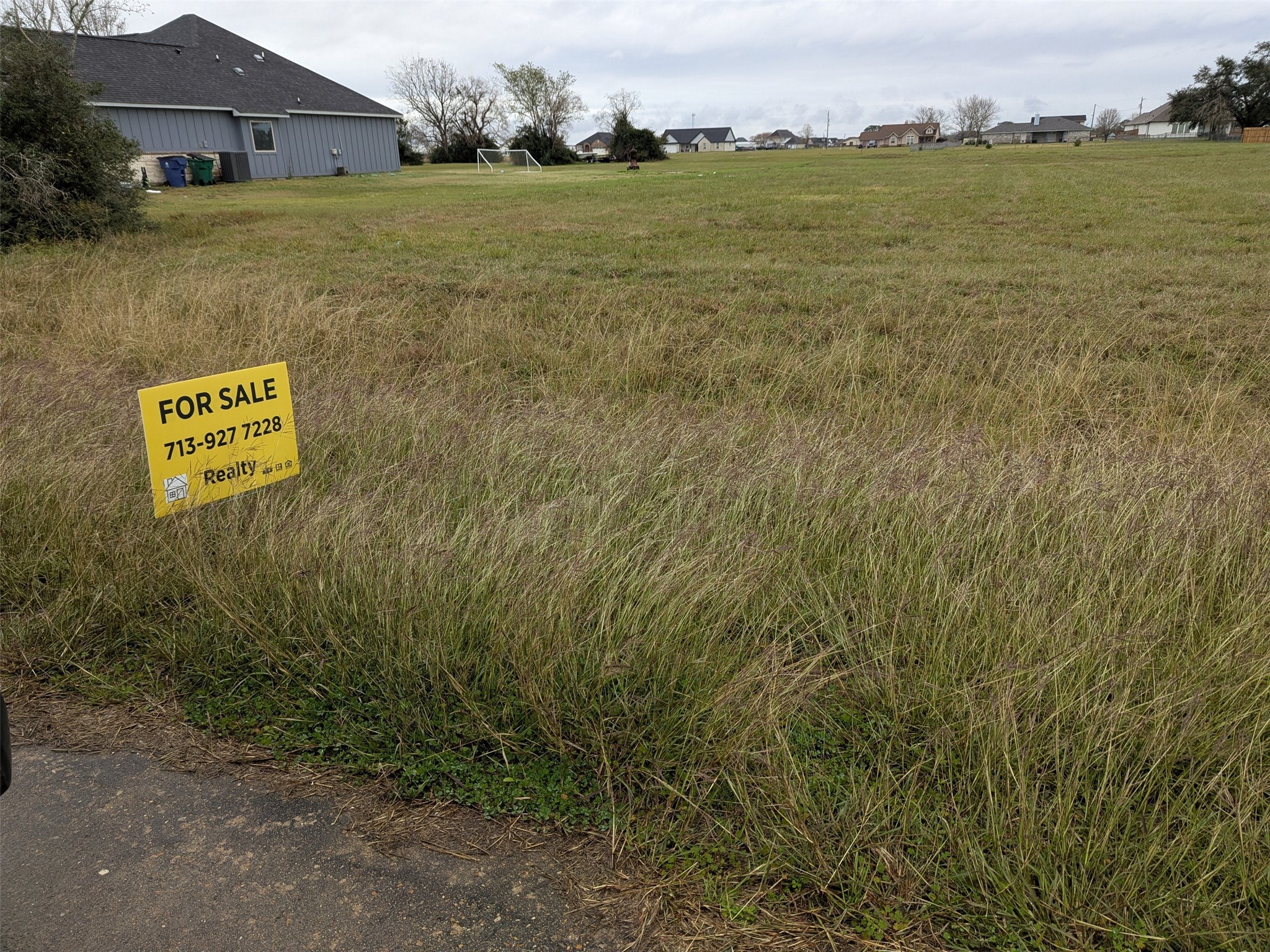 861 Longhorn Trail Angleton, TX 77515 - Photo 3 of 6 a view of a big yard with an buildings and grass