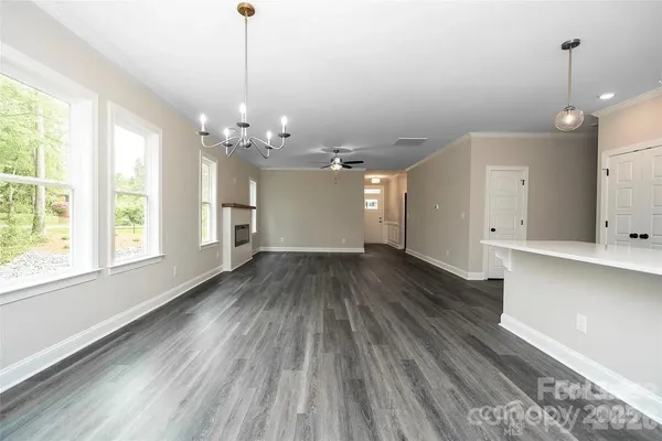 a view of a room with wooden floor and window