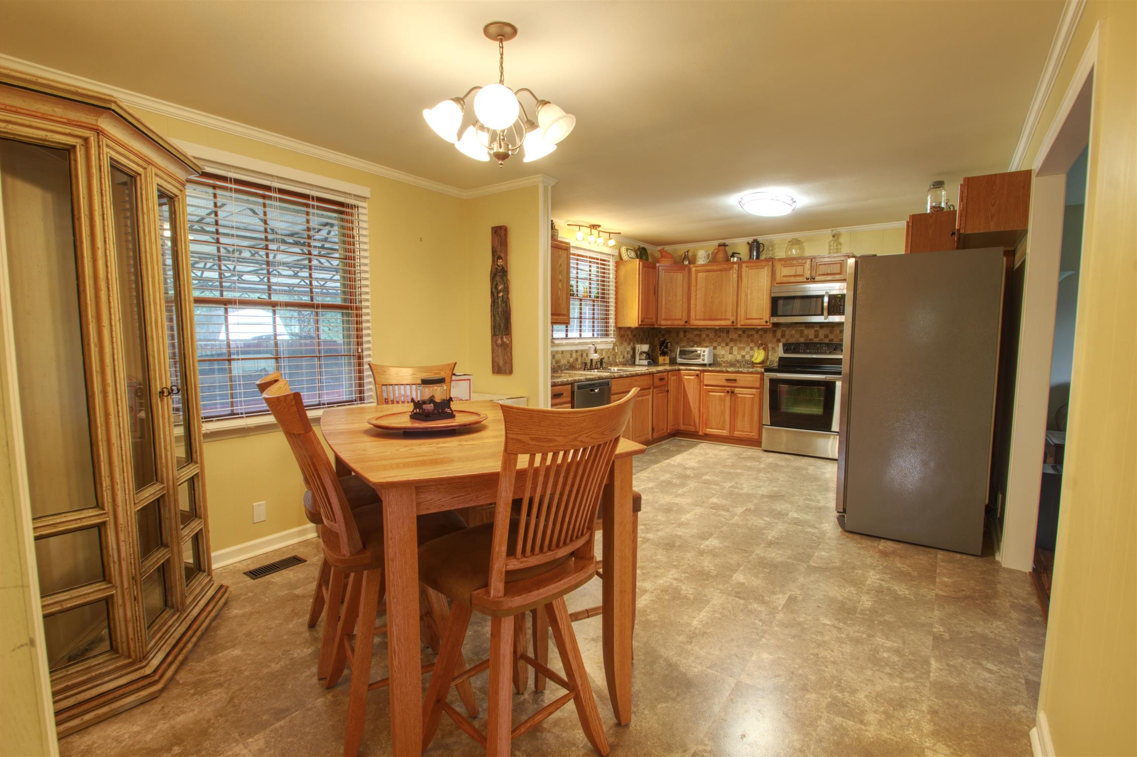 503 Terry Lane Lebanon, TN 37087 - Photo 8 of 16 a dining room with stainless steel appliances wooden floor dining table and chairs