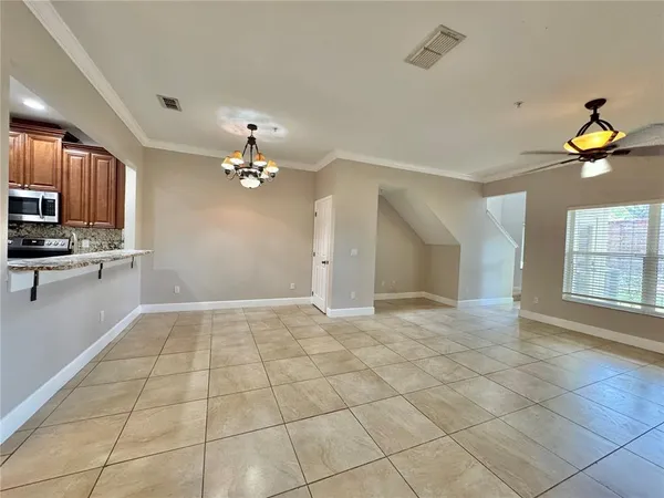a view of an empty room with a kitchen