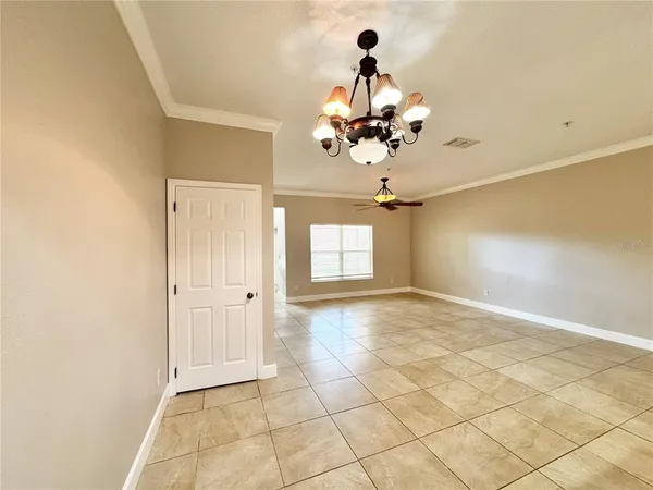 a view of a chandelier fan and entryway