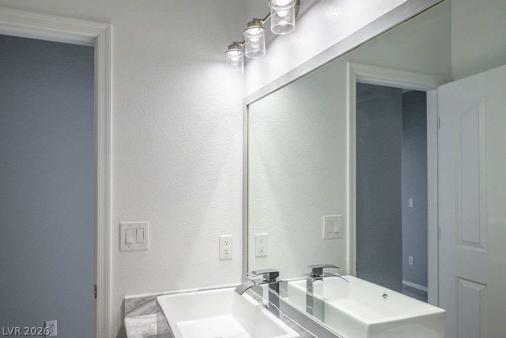 3591 Driving Range Street Las Vegas, NV 89122 - Photo 46 of 79 This sleek bathroom features a modern vanity with ample mirror space.